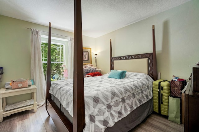 11132 Running Pine Dr, Riverview, FL 33569 - bedroom featuring wood finished floors and a textured ceiling