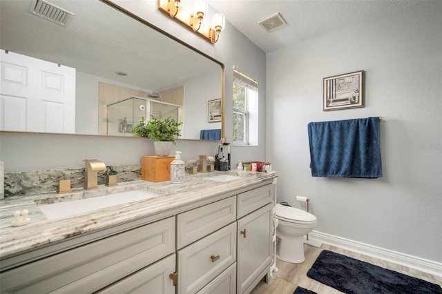 11132 Running Pine Dr, Riverview, FL 33569 - full bathroom with double vanity, a shower stall, and a textured ceiling