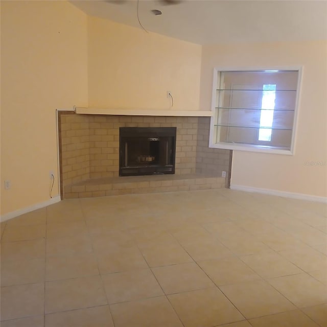 7674 37th Street Cir E, Sarasota, FL 34243 - unfurnished living room featuring a brick fireplace and tile patterned floors