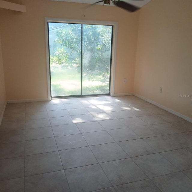 7674 37th Street Cir E, Sarasota, FL 34243 - empty room with tile patterned floors and a ceiling fan