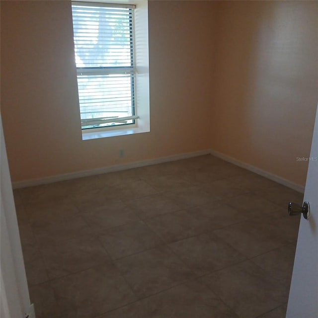 7674 37th Street Cir E, Sarasota, FL 34243 - empty room featuring baseboards and tile patterned flooring