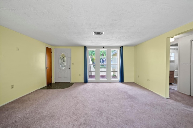 4371 Otter Way, New Port Richey, FL 34653 - unfurnished living room with carpet floors and a textured ceiling