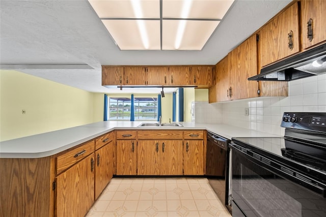 4371 Otter Way, New Port Richey, FL 34653 - kitchen with black appliances, under cabinet range hood, light countertops, backsplash, and brown cabinets