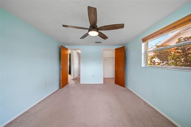 4371 Otter Way, New Port Richey, FL 34653 - unfurnished bedroom featuring carpet, ceiling fan, and a spacious closet