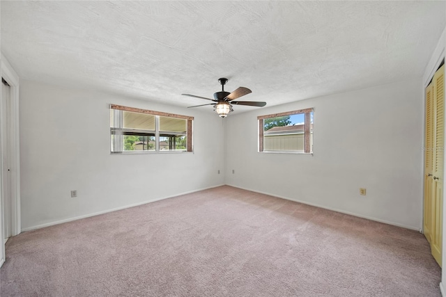 4371 Otter Way, New Port Richey, FL 34653 - unfurnished bedroom featuring light colored carpet, multiple windows, and a ceiling fan
