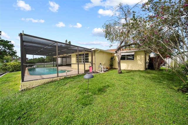 4371 Otter Way, New Port Richey, FL 34653 - rear view of house featuring a lawn, stucco siding, and a lanai
