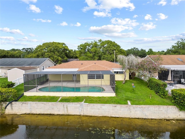 4371 Otter Way, New Port Richey, FL 34653 - rear view of house with a lanai, a lawn, an outdoor pool, a water view, and a patio