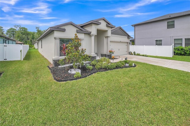 12591 Vander Way, New Port Richey, FL 34654 - view of front of home featuring stucco siding, concrete driveway, and a garage
