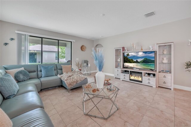 12591 Vander Way, New Port Richey, FL 34654 - living area featuring light tile patterned floors and baseboards