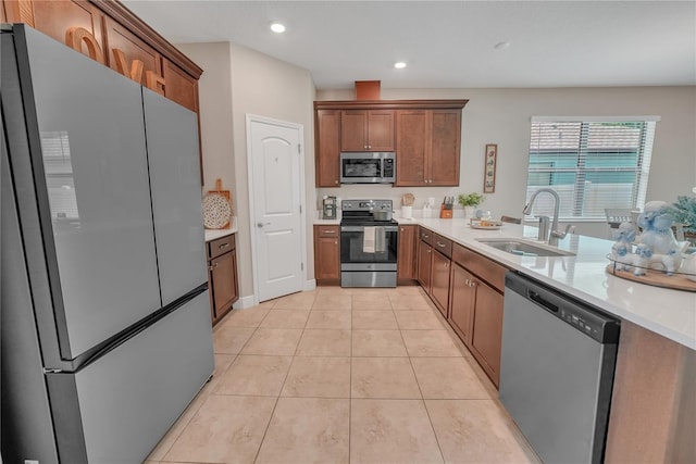12591 Vander Way, New Port Richey, FL 34654 - kitchen featuring stainless steel appliances, light countertops, brown cabinets, and recessed lighting