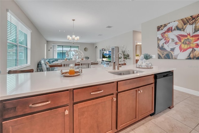12591 Vander Way, New Port Richey, FL 34654 - kitchen with stainless steel dishwasher, open floor plan, light countertops, light tile patterned floors, and a chandelier