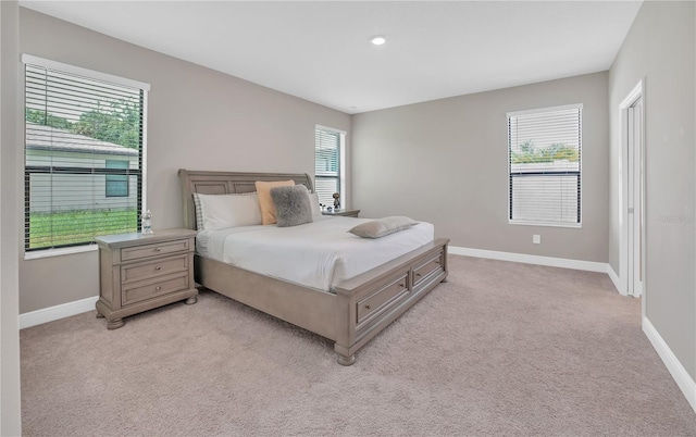 12591 Vander Way, New Port Richey, FL 34654 - bedroom with multiple windows, light carpet, and recessed lighting