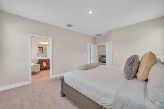 12591 Vander Way, New Port Richey, FL 34654 - bedroom featuring light colored carpet and ensuite bath