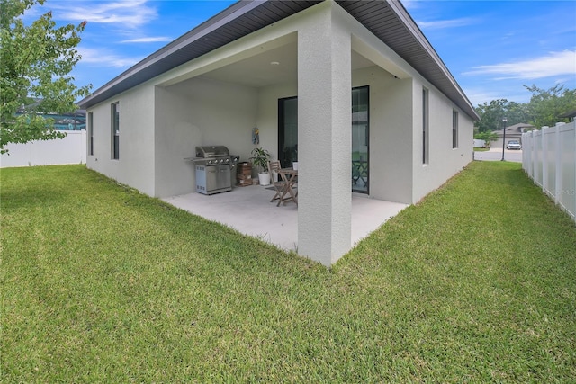 12591 Vander Way, New Port Richey, FL 34654 - back of property featuring stucco siding and a patio
