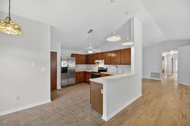 12331 Yellow Rose Cir, Riverview, FL 33569 - kitchen with stainless steel appliances, under cabinet range hood, lofted ceiling, light countertops, and a peninsula