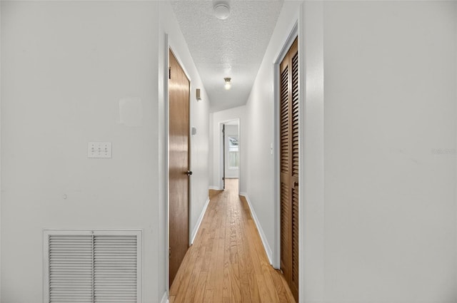 12331 Yellow Rose Cir, Riverview, FL 33569 - corridor featuring a textured ceiling and light wood finished floors