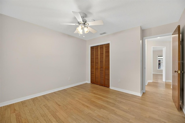 12331 Yellow Rose Cir, Riverview, FL 33569 - unfurnished bedroom with a closet, light wood-style floors, and a ceiling fan