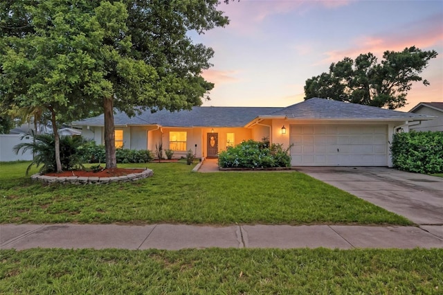 12331 Yellow Rose Cir, Riverview, FL 33569 - ranch-style home featuring a garage, concrete driveway, a lawn, and stucco siding