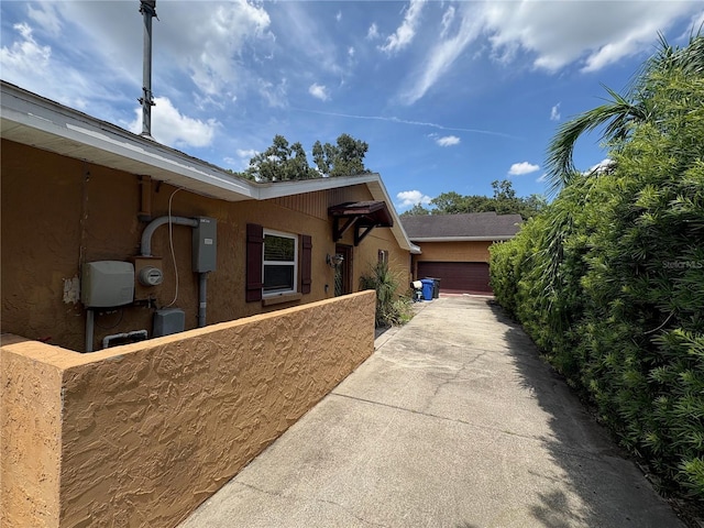 3411 Holland Dr, Brandon, FL 33511 - view of side of property featuring a garage, concrete driveway, and stucco siding