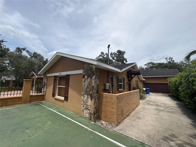 3411 Holland Dr, Brandon, FL 33511 - view of side of property featuring stucco siding and concrete driveway