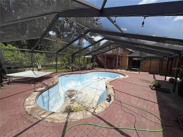 3411 Holland Dr, Brandon, FL 33511 - outdoor pool featuring a patio area, stairway, and glass enclosure
