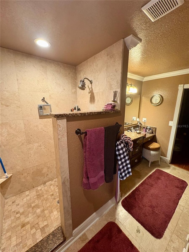3411 Holland Dr, Brandon, FL 33511 - bathroom with a walk in shower, a textured ceiling, crown molding, vanity, and tile patterned floors