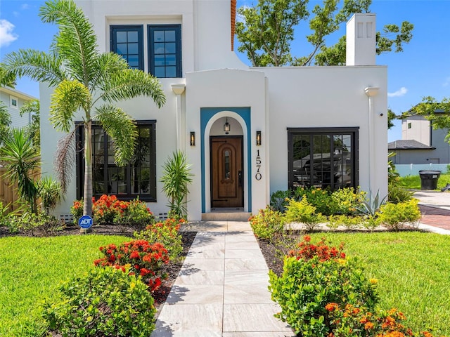 1570 48th Ave N, Saint Petersburg, FL 33703 - entrance to property with stucco siding, a chimney, and a yard