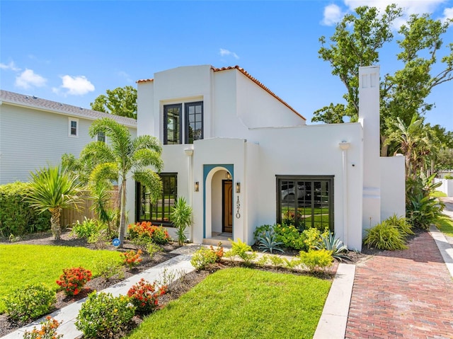 1570 48th Ave N, Saint Petersburg, FL 33703 - mediterranean / spanish-style home featuring a front yard and stucco siding