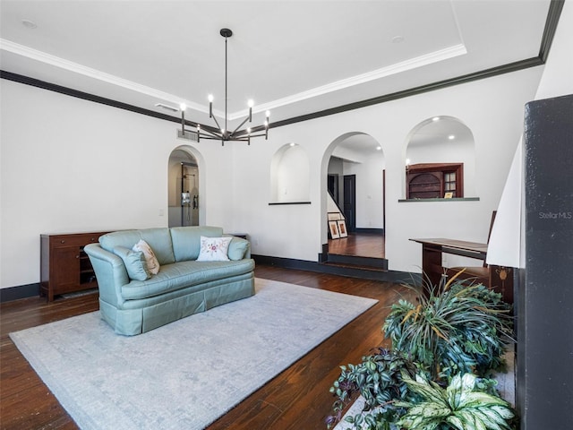 1570 48th Ave N, Saint Petersburg, FL 33703 - living room with arched walkways, dark wood finished floors, a raised ceiling, a chandelier, and ornamental molding