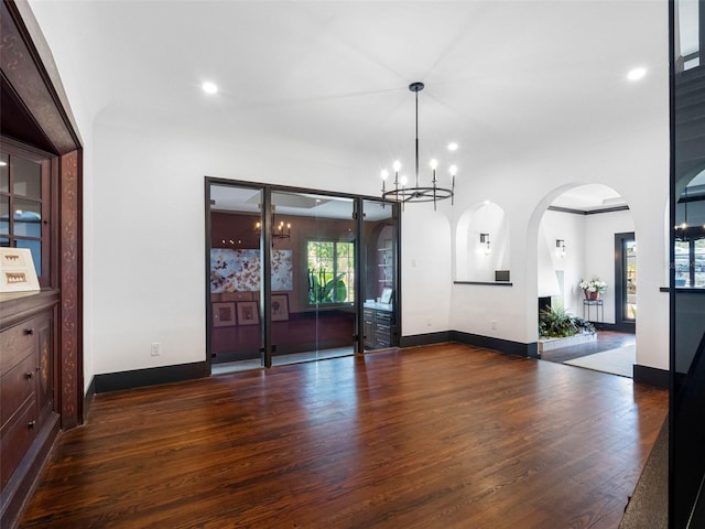 1570 48th Ave N, Saint Petersburg, FL 33703 - empty room with wood finished floors, a chandelier, recessed lighting, and arched walkways