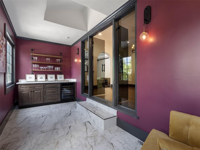 1570 48th Ave N, Saint Petersburg, FL 33703 - indoor dry bar with arched walkways, beverage cooler, crown molding, and light marble finish flooring
