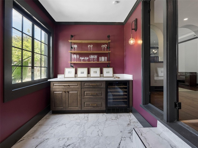 1570 48th Ave N, Saint Petersburg, FL 33703 - indoor dry bar featuring beverage cooler, crown molding, arched walkways, and light marble finish flooring