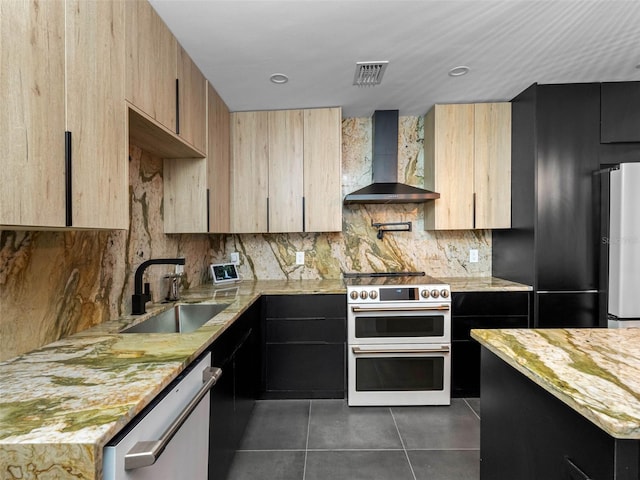 1570 48th Ave N, Saint Petersburg, FL 33703 - kitchen with light stone counters, stainless steel appliances, wall chimney range hood, dark tile patterned floors, and recessed lighting