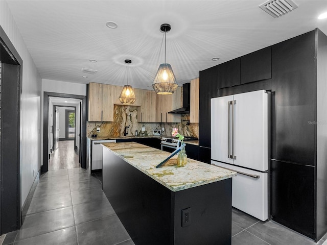 1570 48th Ave N, Saint Petersburg, FL 33703 - kitchen with appliances with stainless steel finishes, dark cabinetry, wall chimney exhaust hood, a center island, and backsplash
