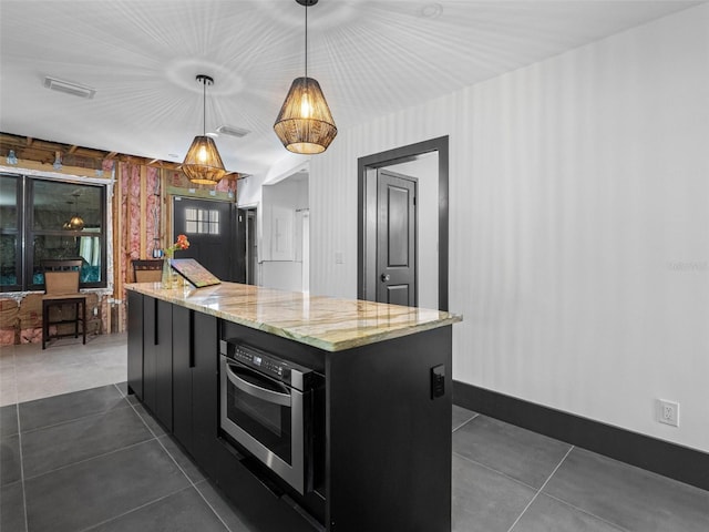 1570 48th Ave N, Saint Petersburg, FL 33703 - kitchen featuring dark cabinets, dark tile patterned flooring, oven, and hanging light fixtures