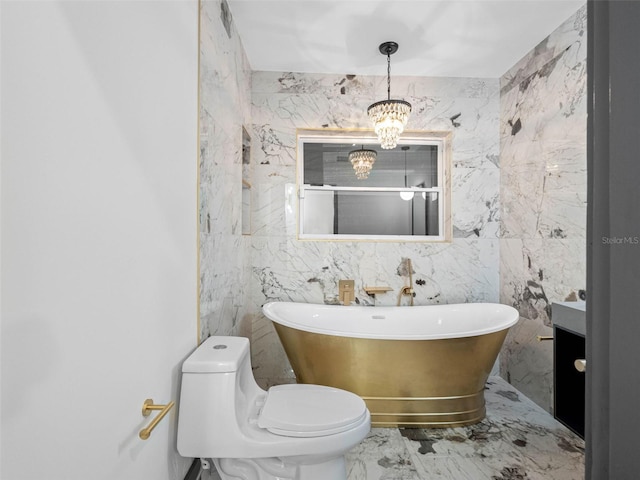 1570 48th Ave N, Saint Petersburg, FL 33703 - bathroom with marble tiled flooring, a freestanding bath, a chandelier, vanity, and tile walls