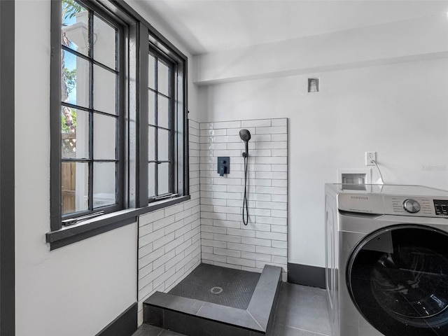 1570 48th Ave N, Saint Petersburg, FL 33703 - full bath with washer / clothes dryer, tiled shower, and tile patterned flooring
