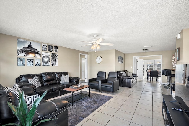 6801 34th Ave W, Bradenton, FL 34209 - living area featuring light tile patterned floors, ceiling fan, and a textured ceiling