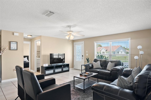 6801 34th Ave W, Bradenton, FL 34209 - living area featuring light tile patterned flooring, a ceiling fan, and a textured ceiling