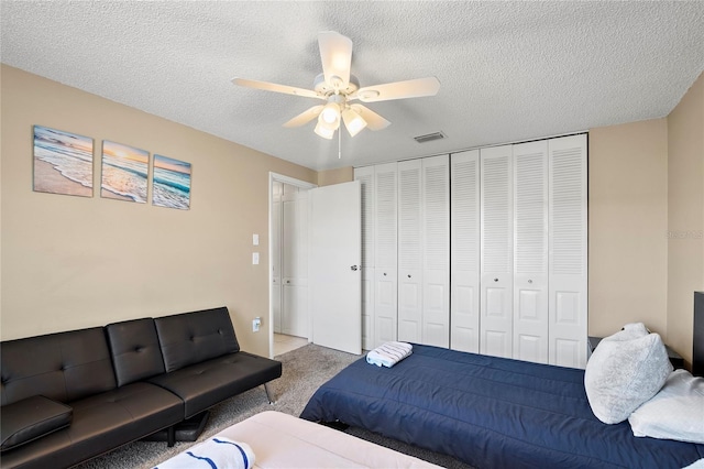 6801 34th Ave W, Bradenton, FL 34209 - bedroom with carpet floors, a textured ceiling, a closet, and a ceiling fan