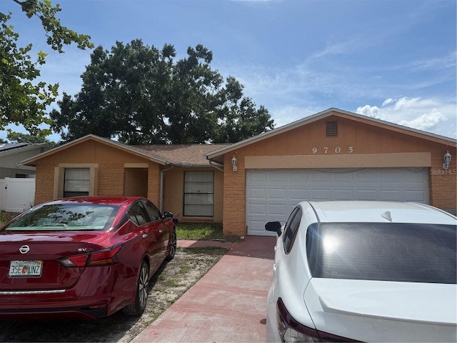 9705 Kingsburgh Ct, Tampa, FL 33615 - ranch-style house with brick siding and a garage