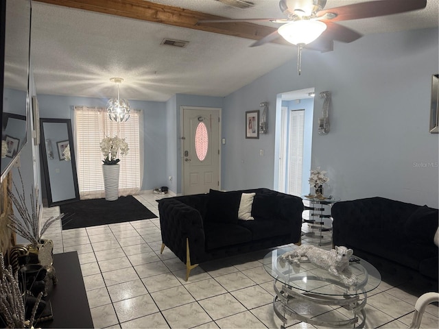 9705 Kingsburgh Ct, Tampa, FL 33615 - living room featuring light tile patterned flooring, a ceiling fan, a chandelier, and a textured ceiling