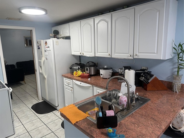 9705 Kingsburgh Ct, Tampa, FL 33615 - kitchen featuring white appliances, white cabinetry, dark countertops, and light tile patterned floors