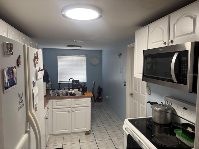 9705 Kingsburgh Ct, Tampa, FL 33615 - kitchen with white appliances, white cabinets, and dark countertops