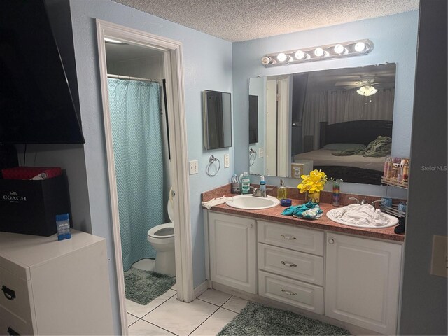 9705 Kingsburgh Ct, Tampa, FL 33615 - bathroom with tile patterned floors, ceiling fan, double vanity, a textured ceiling, and connected bathroom