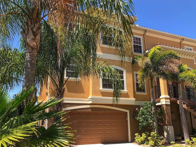 6517 Channelside Dr, New Port Richey, FL 34652 - mediterranean / spanish home with stucco siding, an attached garage, and driveway
