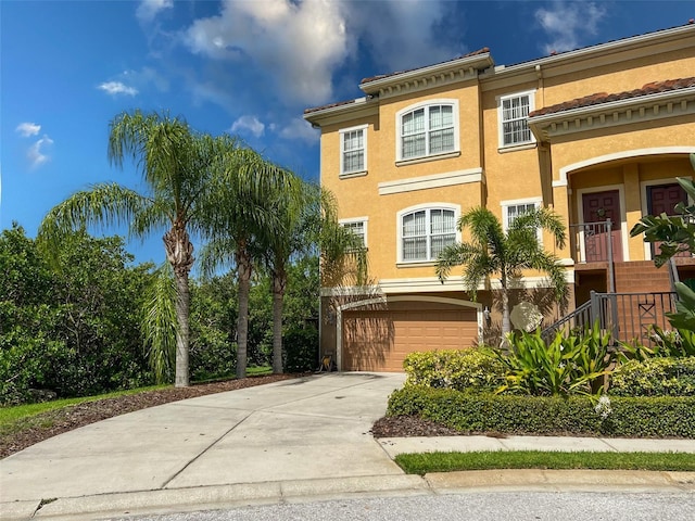 6517 Channelside Dr, New Port Richey, FL 34652 - view of front of property with an attached garage, stucco siding, and concrete driveway