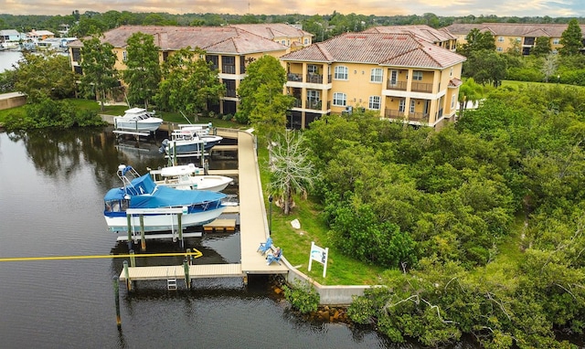6517 Channelside Dr, New Port Richey, FL 34652 - dock area with boat lift, a water view, and view of wooded area