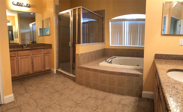 6517 Channelside Dr, New Port Richey, FL 34652 - full bath with two vanities, a tub with jets, a shower stall, and tile patterned floors