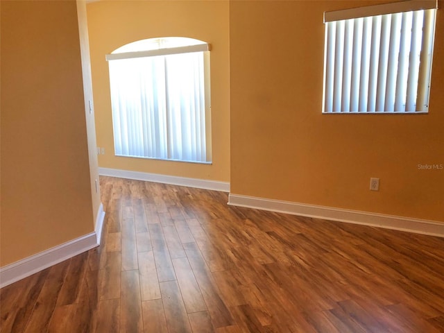 6517 Channelside Dr, New Port Richey, FL 34652 - unfurnished room with baseboards and dark wood-style floors